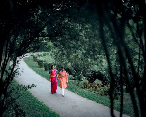 Happy Indian family walking in a park outdoors